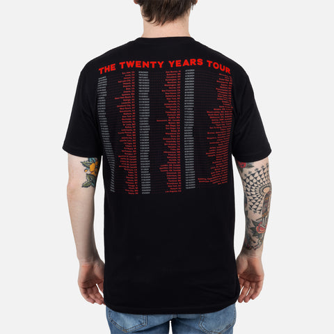 Rear view of black shirt with red text "THE TWENTY YEARS TOUR" and red and white text below showing tour dates